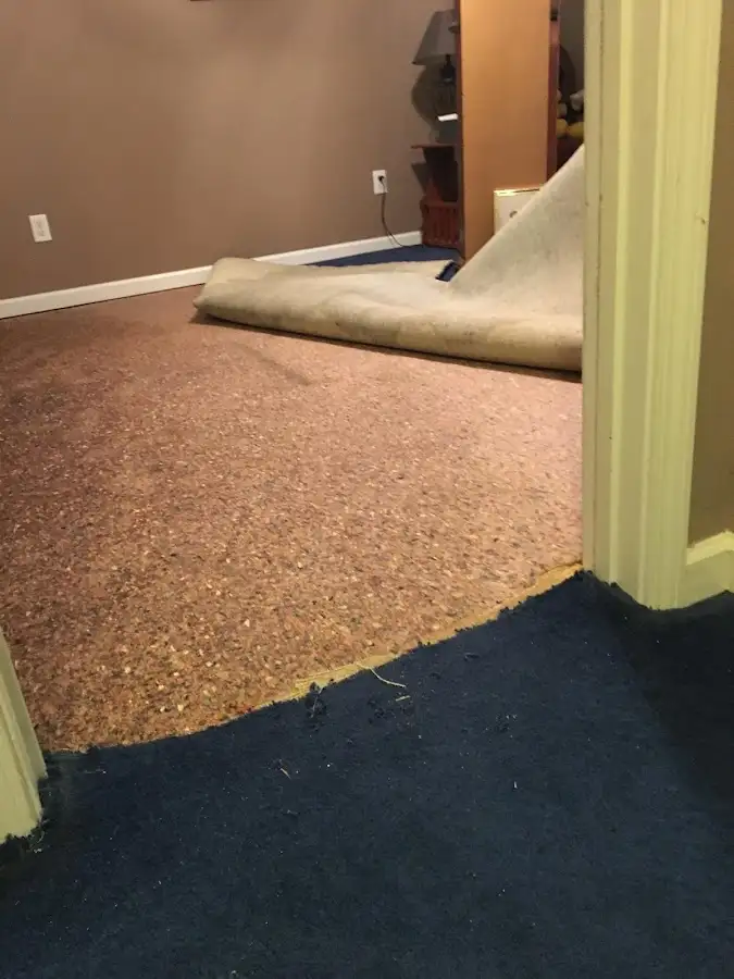 Carpet pad removal revealing water damage during Drying & Dehumidification in Monterey